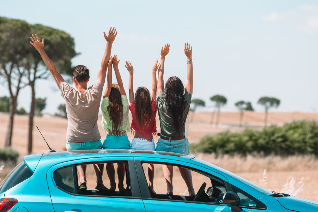 Family on summer vacation traveling by car